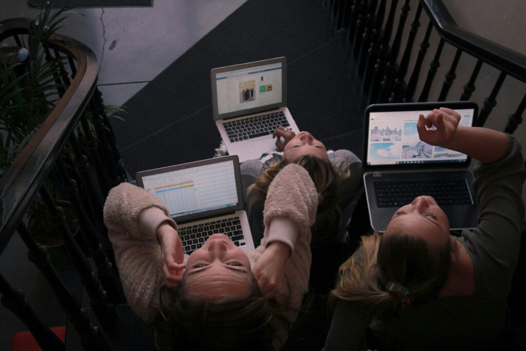 Teenagers working together on computers