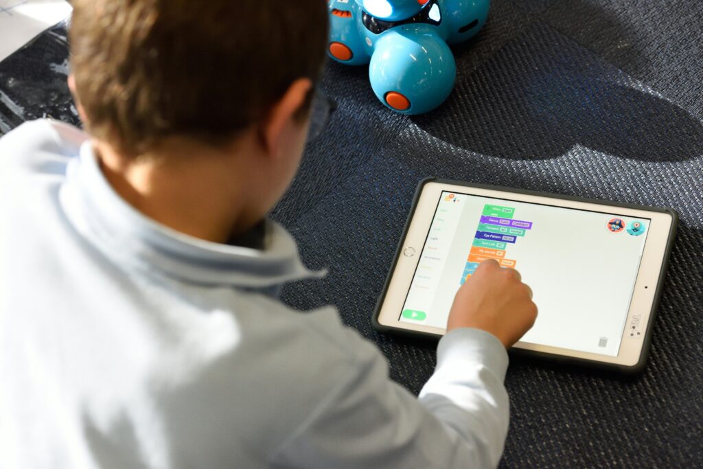 A child playing an interactive learning game on an iPad