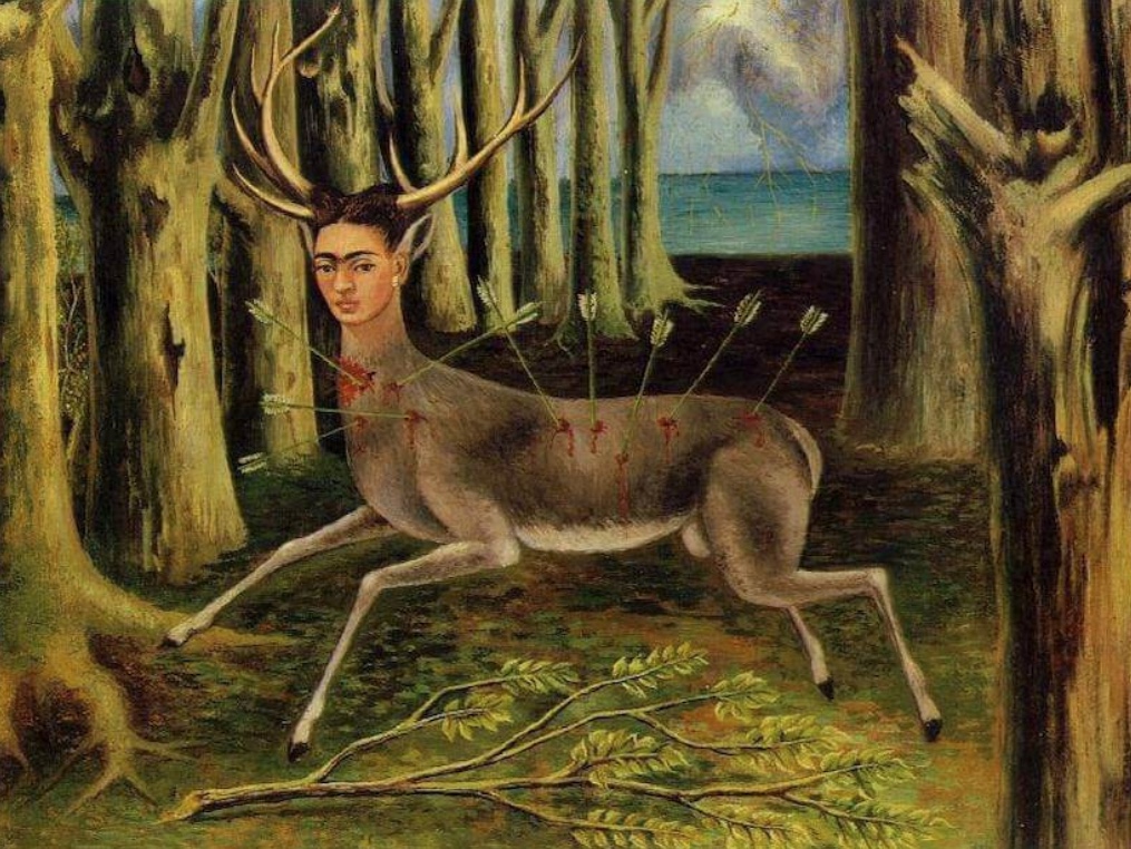 A painting of a forest on the edge of the ocean. In the forest is a deer that has been shot down by arrows. The head of the dear has been replaced with Frida Kahlo's head.