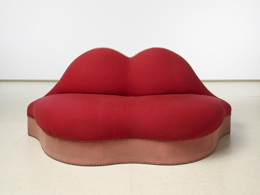 A giant red couch in the shape of a pair of lips. The bottom lip is where you sit, and the top lip is your backrest.